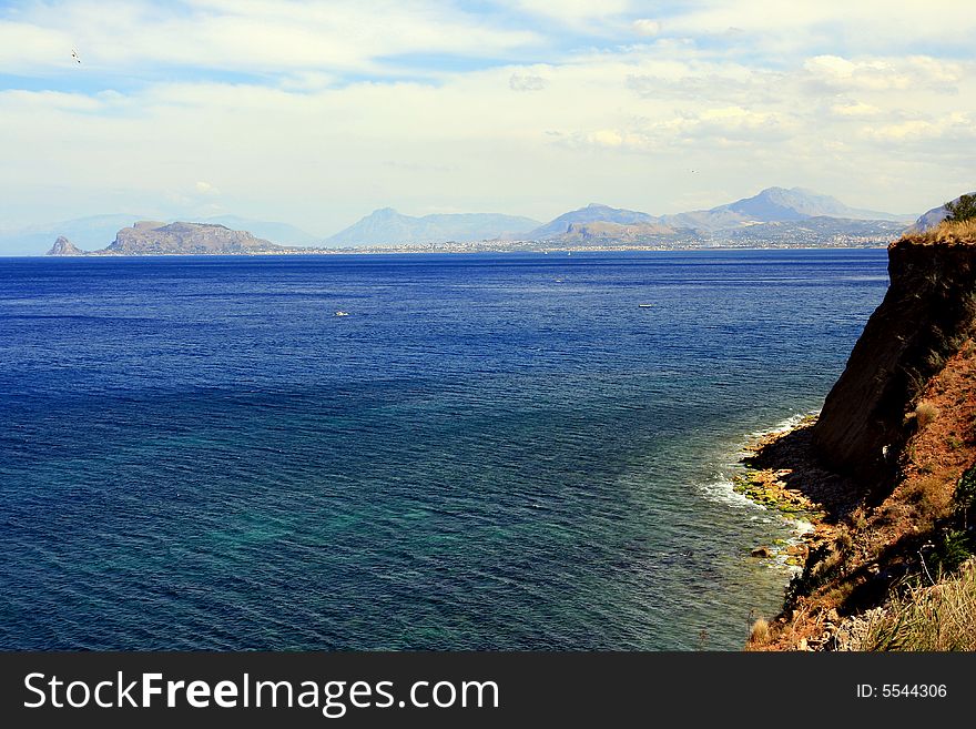 Seascape of blue mediterranean sea and coast an boats, Coast and gulf of Palermo. Island of Sicily, Italy. Seascape of blue mediterranean sea and coast an boats, Coast and gulf of Palermo. Island of Sicily, Italy