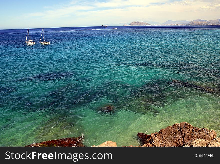 Seascape of blue mediterranean sea and coast an boats, Coast and gulf of Palermo. Island of Sicily, Italy. Seascape of blue mediterranean sea and coast an boats, Coast and gulf of Palermo. Island of Sicily, Italy