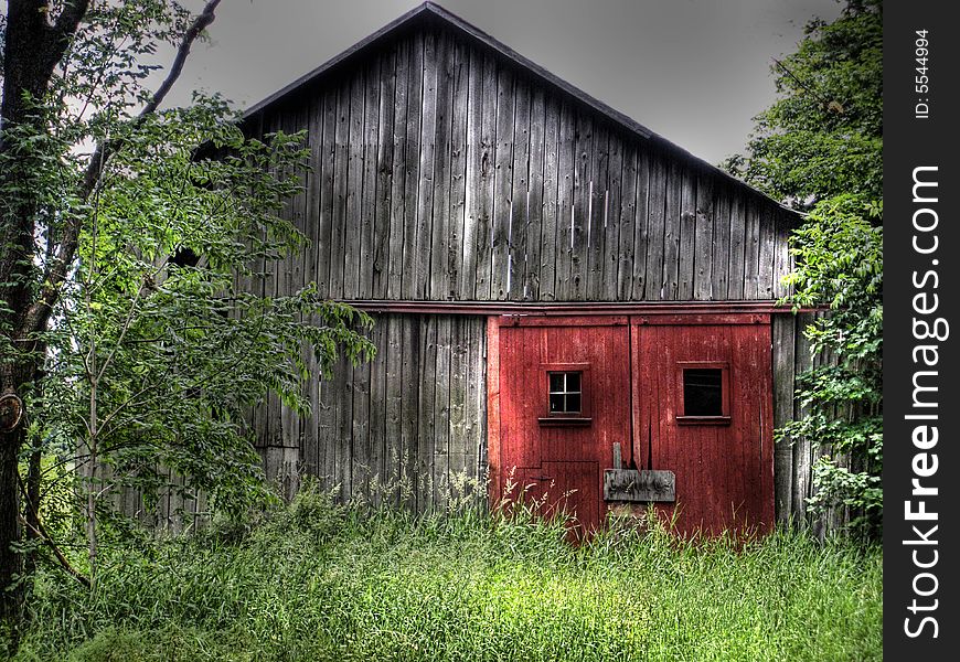 Rustic red doors on a dilapidated barn. Rustic red doors on a dilapidated barn.