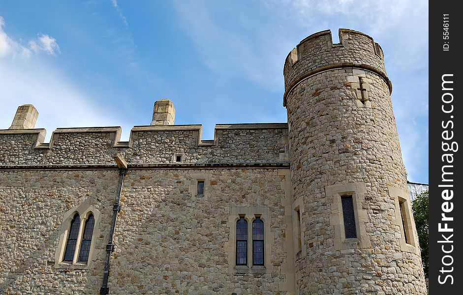 Castle walls and tower with a clear blue sky background