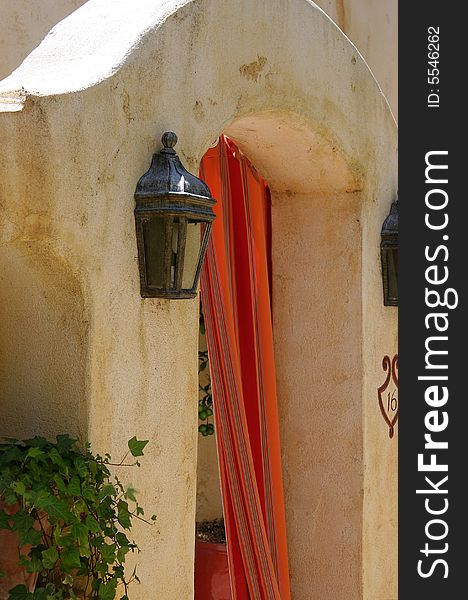 Plaster doorway with sconces and curtain