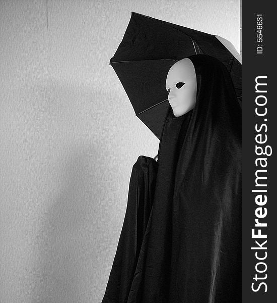 A masked image using an umbrella inside a building expecting it to rain. A masked image using an umbrella inside a building expecting it to rain.