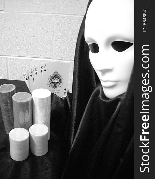 Black and white photo of masked image playing poker. Black and white photo of masked image playing poker.