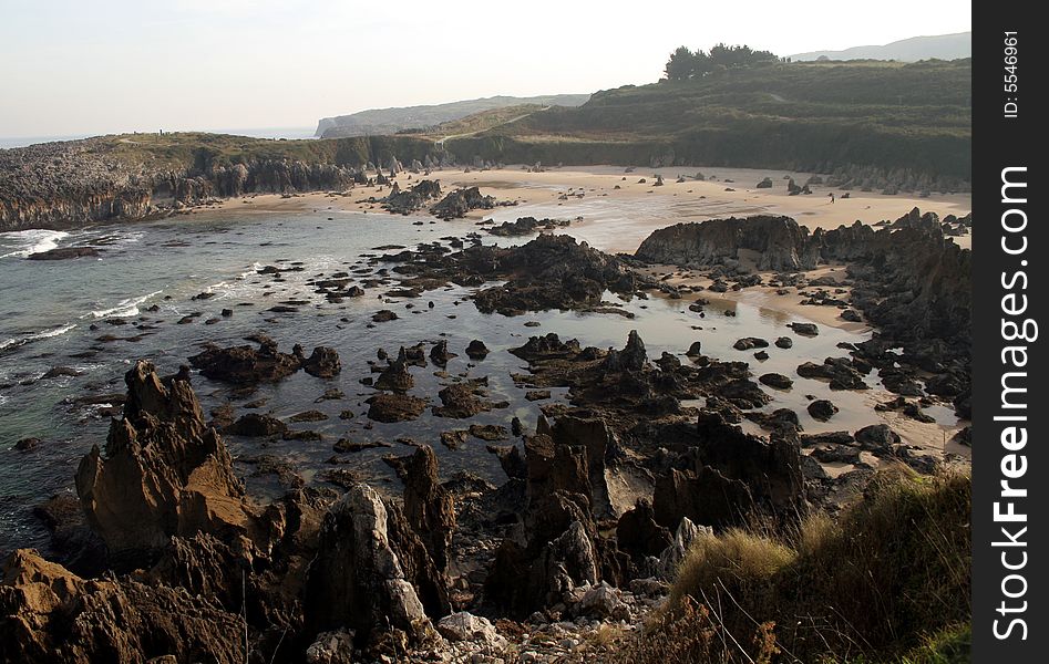 Coastline with rocks and a sand beach on Cantabrigian sea