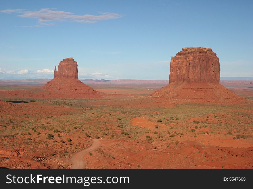 Shot of famous rocks in Monument Valley and the road which makes a loop-tour through the Park. Arizona. USA