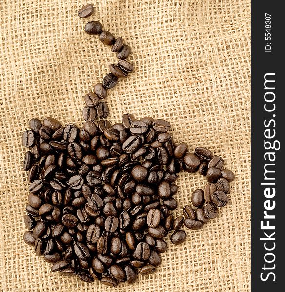 Coffee cup model made of beans on sack