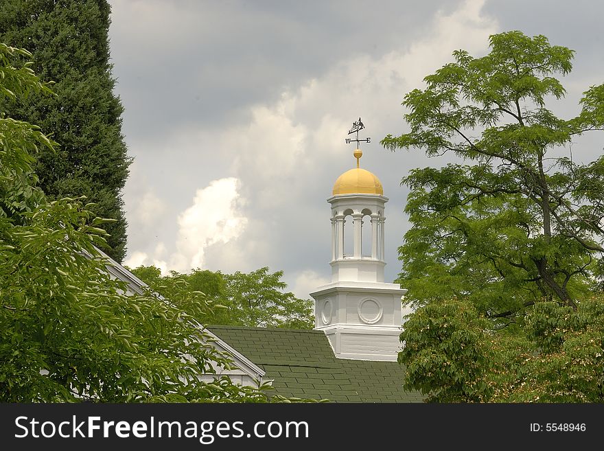 Weather vane on a golden domed cupola lets one know which way the wind is blowing