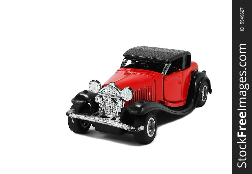 A isolated red and classic toy car. A isolated red and classic toy car.