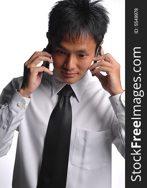 Asian Business Man Busy With Multiple Handphones