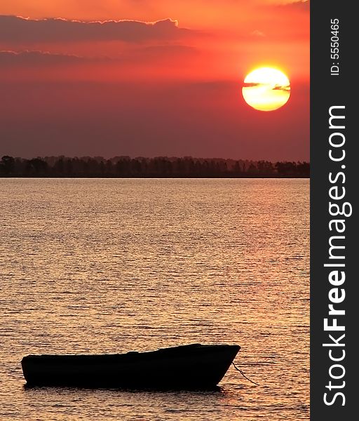 Beautiful boat at sunset in the lake