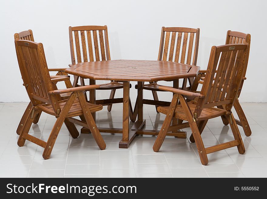 Wooden table and chairs on a tiled floor