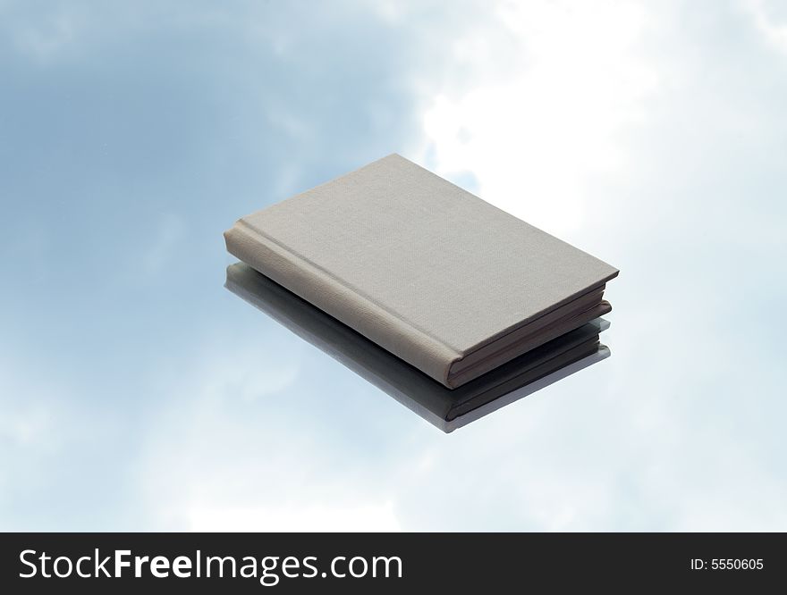 Book lying on background with gray sky and clouds. Book lying on background with gray sky and clouds