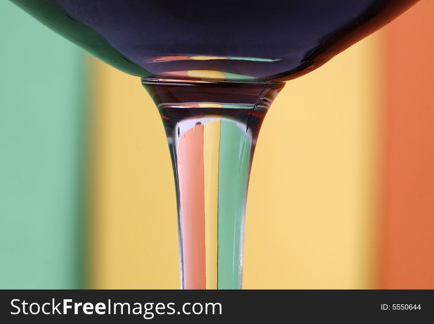 A glass with a simple  green - yellow - orange  color background. A glass with a simple  green - yellow - orange  color background