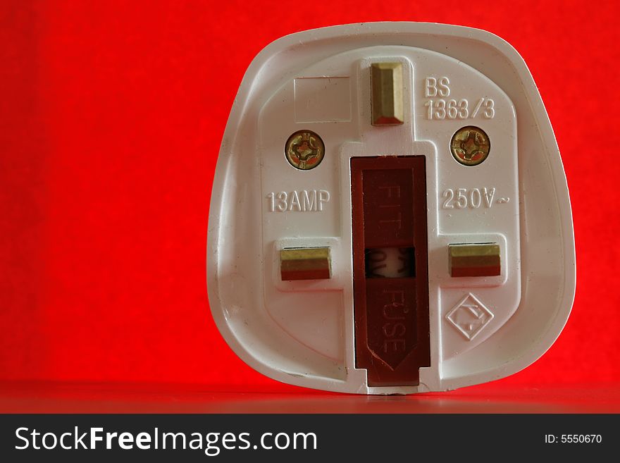 An  electricity fuse in a simple red background. An  electricity fuse in a simple red background