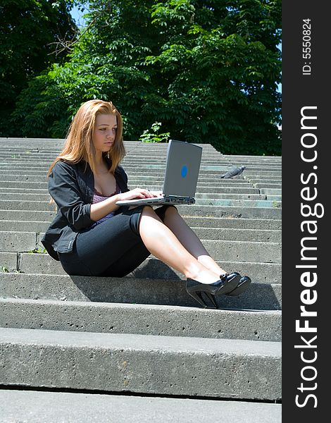 The girl with  laptop on steps