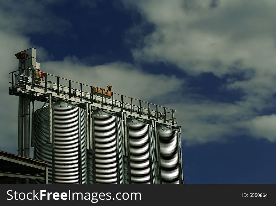 Four Brewery Grain Silos against a cloudy sky