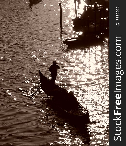 Venice (Italy) postcard: silhouette of a gondolier with clients in gondola rowing at sunset; sepia image

*image also available in full color. Venice (Italy) postcard: silhouette of a gondolier with clients in gondola rowing at sunset; sepia image

*image also available in full color