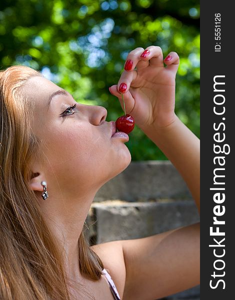Portrait of the beautiful young girl on nature with cherry. Portrait of the beautiful young girl on nature with cherry