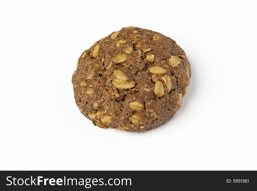 One delicious cocoa cookie with oat-flakes isolated on white background