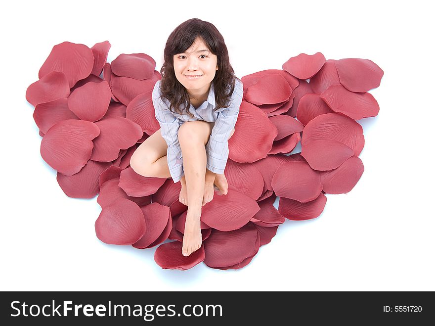 A beautiful lady sits on red heart shape petals. A beautiful lady sits on red heart shape petals