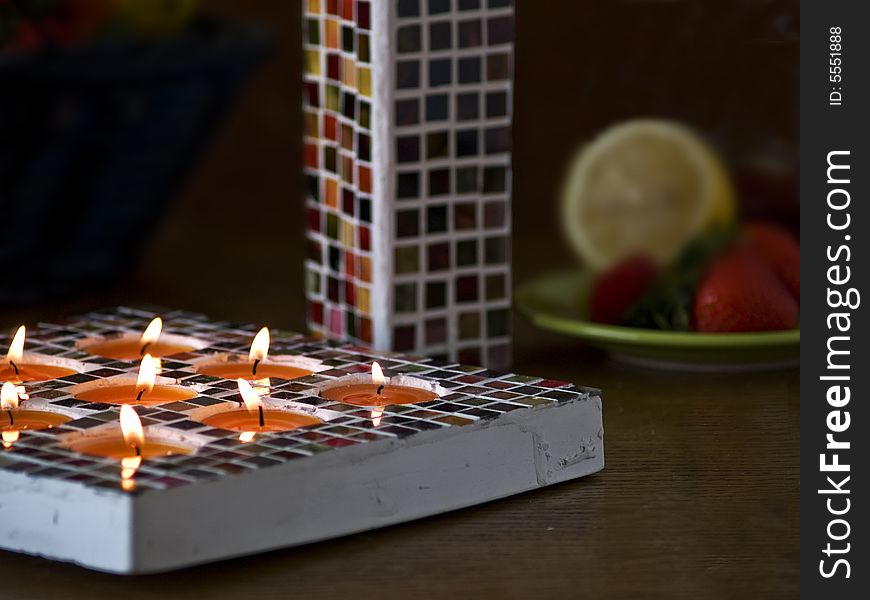 Close up of Mosaic candle holder and Mosaic vase with one rose, dark background with space for text, romantic impression