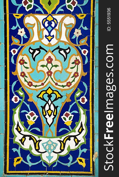 Details of a colorful mosaic designed with ceramic tiles depicting floral patterns. Details of a colorful mosaic designed with ceramic tiles depicting floral patterns