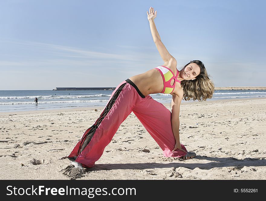 Woman stretching at the beach