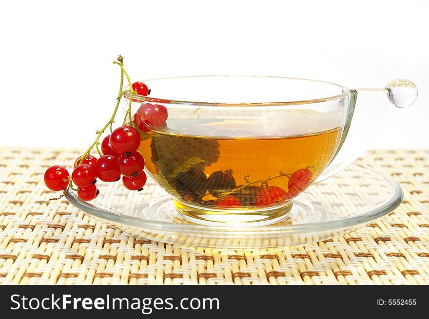 Red currant and herbal tea in a transparent cup. Red currant and herbal tea in a transparent cup