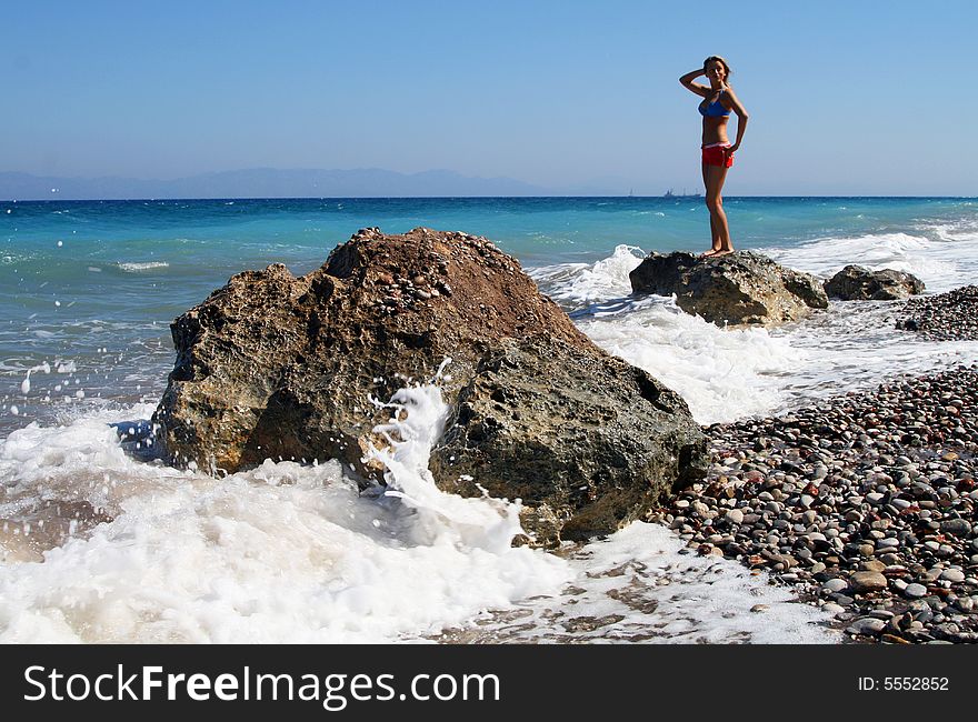 Women standing in the sea on rocks. Women standing in the sea on rocks