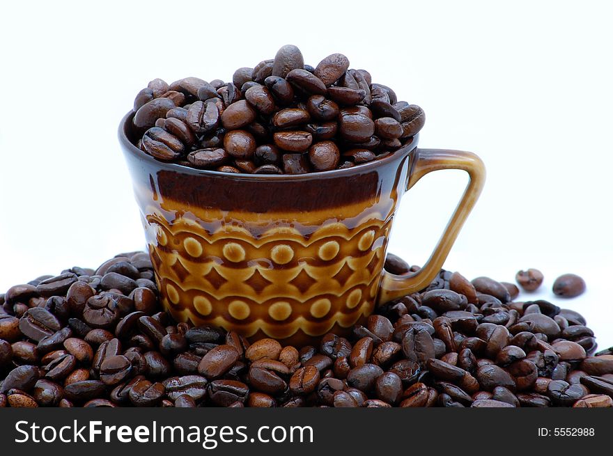 Cup with coffee beans isolated on the white background
