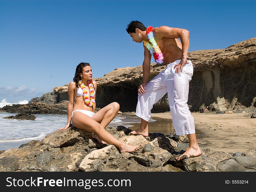 Man And Woman In The Seaside With Flower Necklace