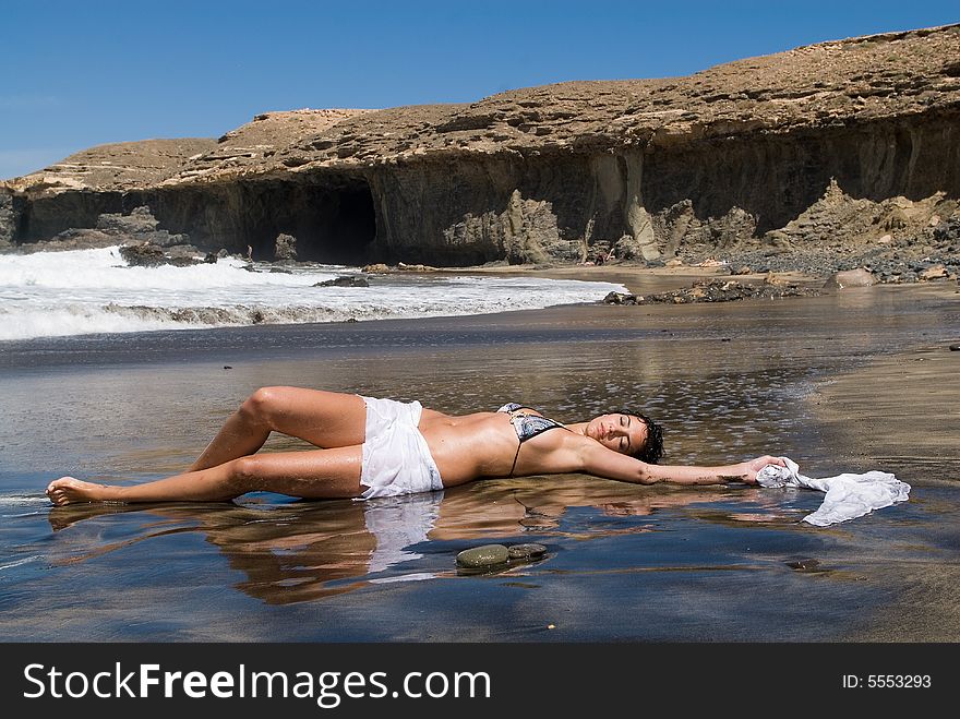 Woman lying in the seaside of the beach