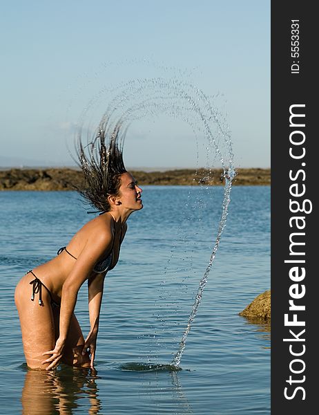 Woman Playing With Her Hair In The Sea