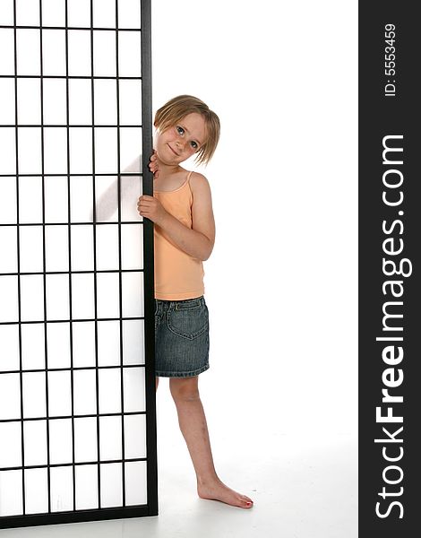 Cute girl standing next to a black and white screen with grids.