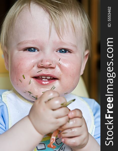 Laughing child soiled with salad