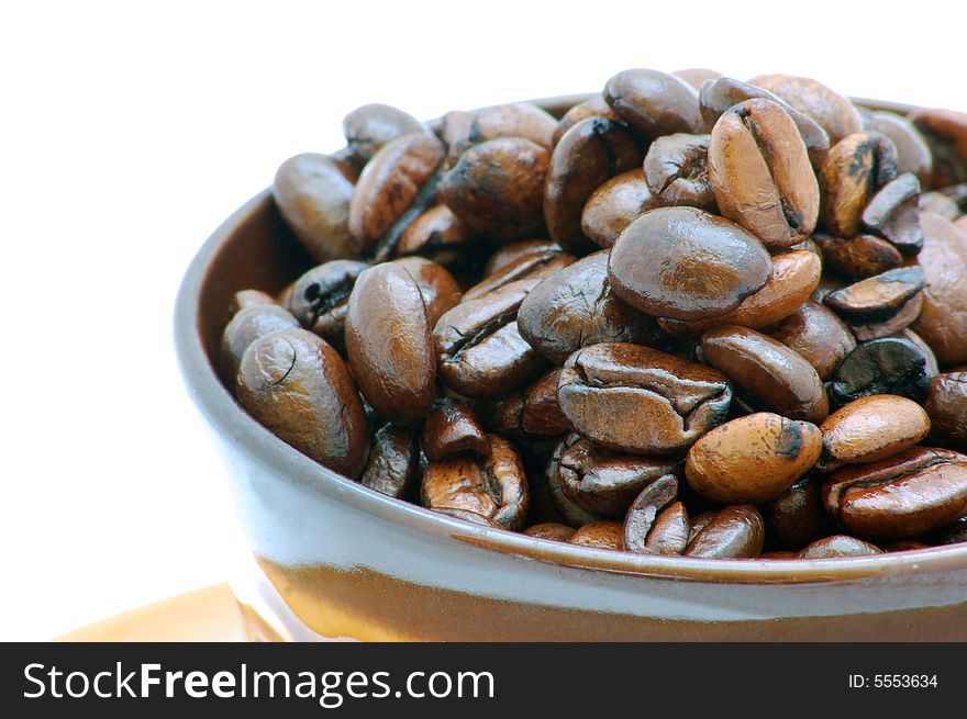 Brown coffee beans isolated on the white background