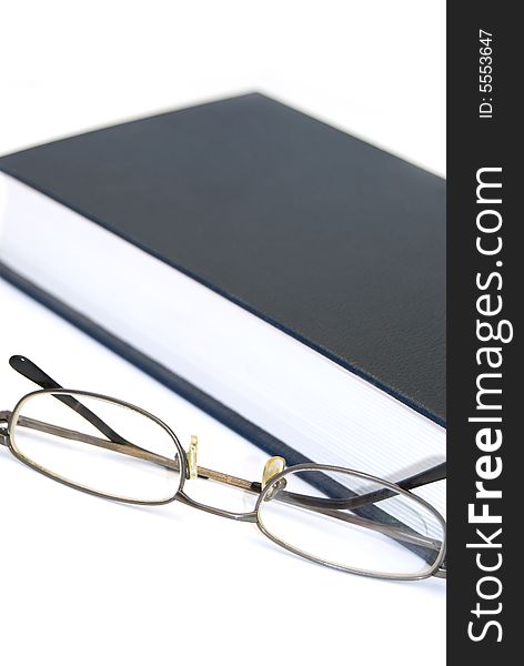 Book and glasses on a white background