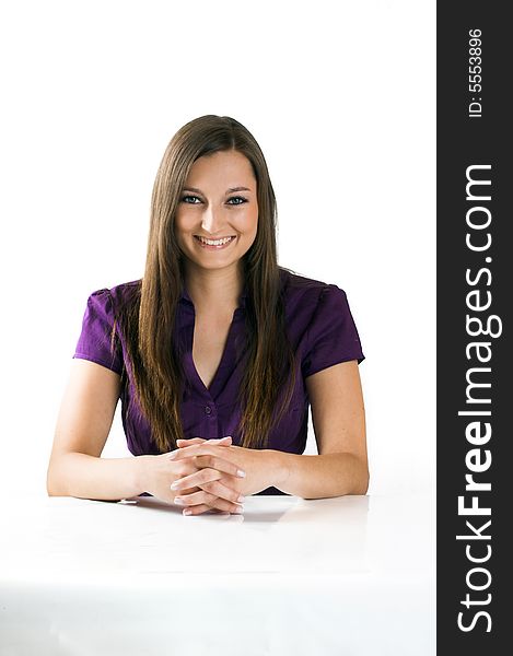 Young beautiful businesswoman on a white table against white background. Young beautiful businesswoman on a white table against white background