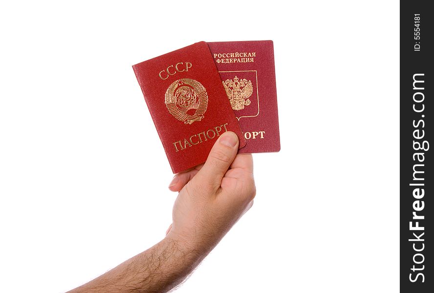 Soviet Union (USSR) passport and Russian Federation passport in the right hand. Isolated on white. Soviet Union (USSR) passport and Russian Federation passport in the right hand. Isolated on white