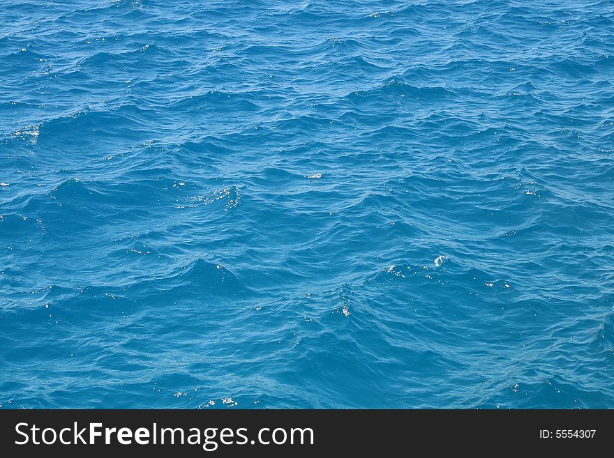 Water waves in the blue sea. Water waves in the blue sea