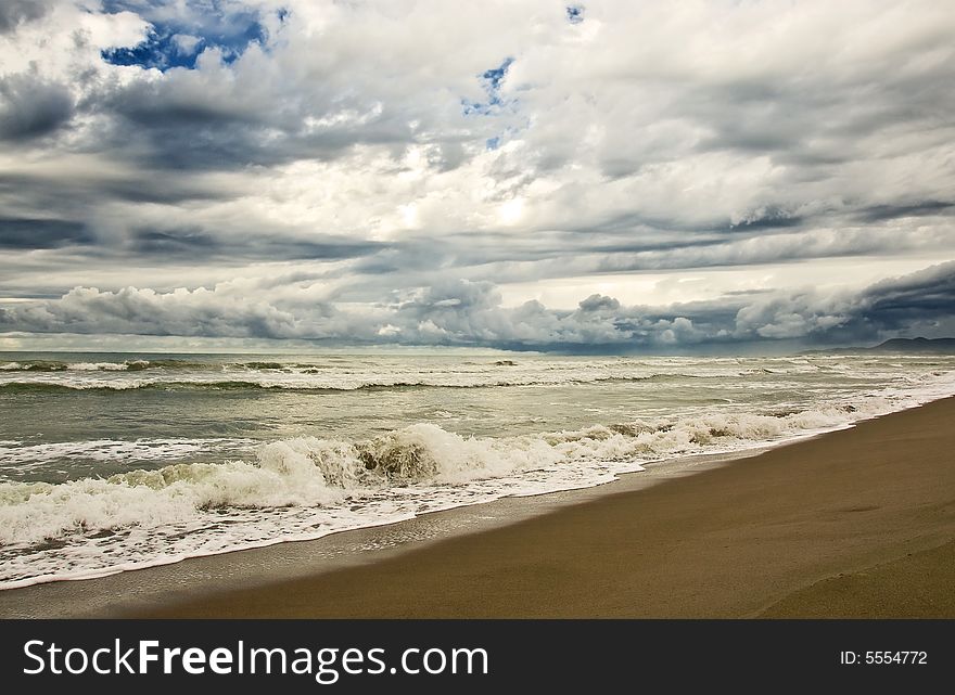 Empty beach during a storm with heavy clouds and waves. Empty beach during a storm with heavy clouds and waves
