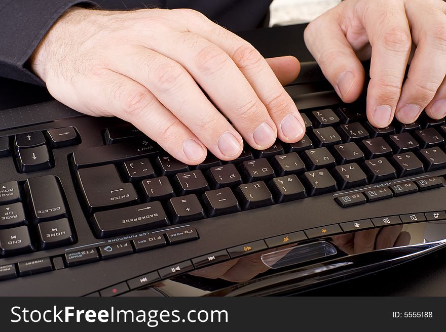 Caucasian male hands on a keyboard. Caucasian male hands on a keyboard.