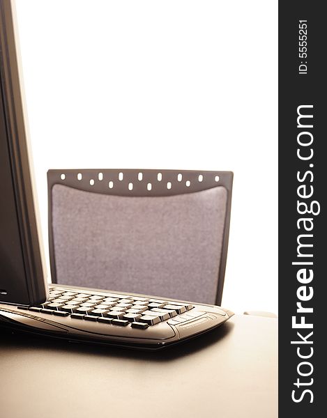 Abstract of a computer keyboard with part of monitor and office chair back, suitable for background image or conceptual design. Abstract of a computer keyboard with part of monitor and office chair back, suitable for background image or conceptual design.