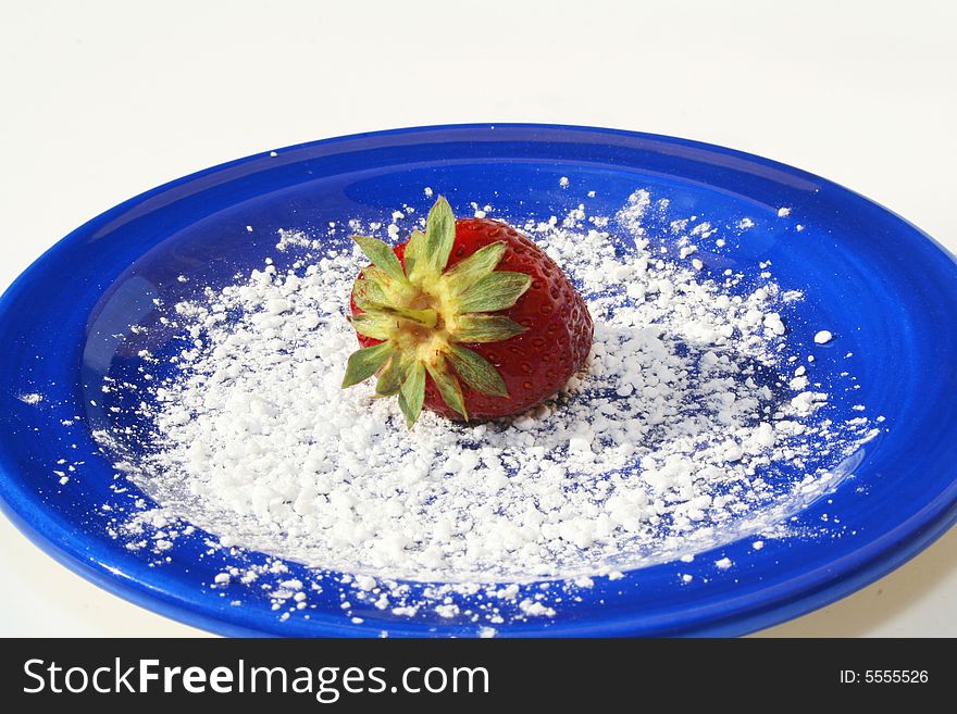 Single strawberry on plate