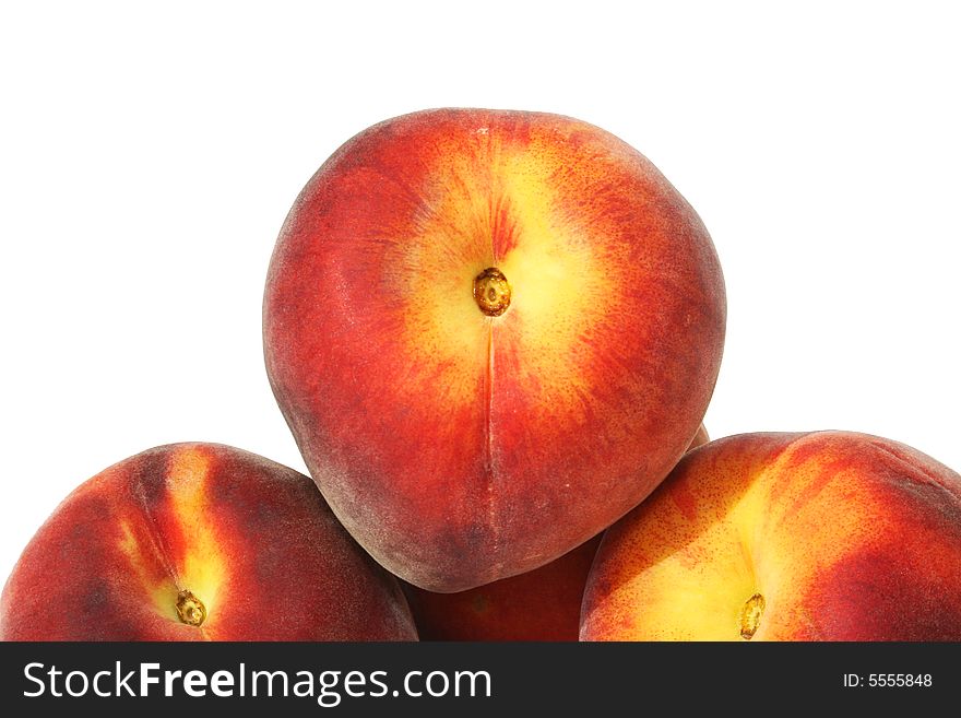 Closeup of three peaches on a white background