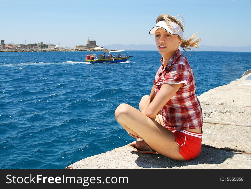Girl sitting in the shipping port. Girl sitting in the shipping port