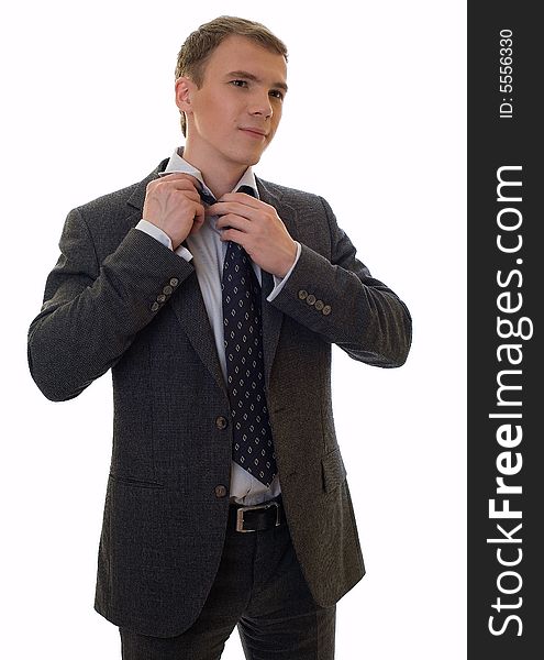 Young man dressing a necktie on a white background. Young man dressing a necktie on a white background