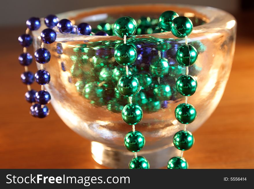 Necklace with green and blue pearls in a bowl