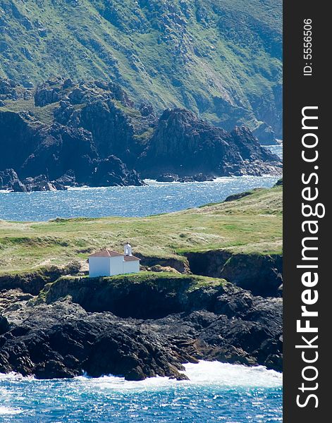 Chapel on a tiny island among the mountains and by the sea