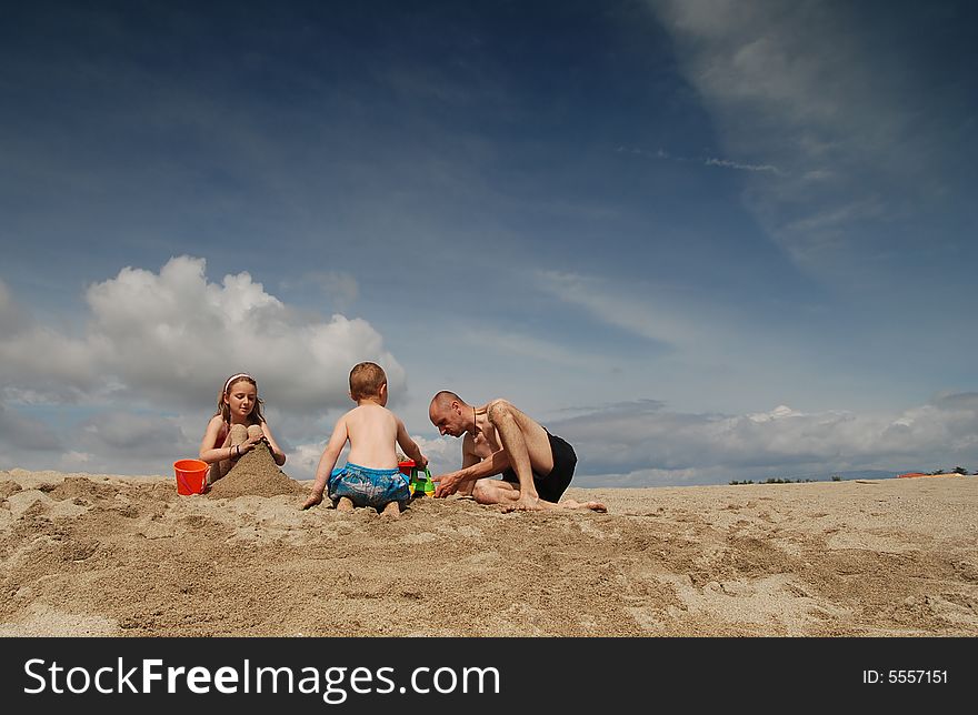 Dad and children having fun on the beach. Dad and children having fun on the beach